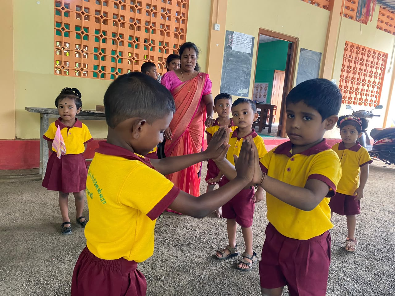 Kindergarten children practising a playful activity with their teacher
