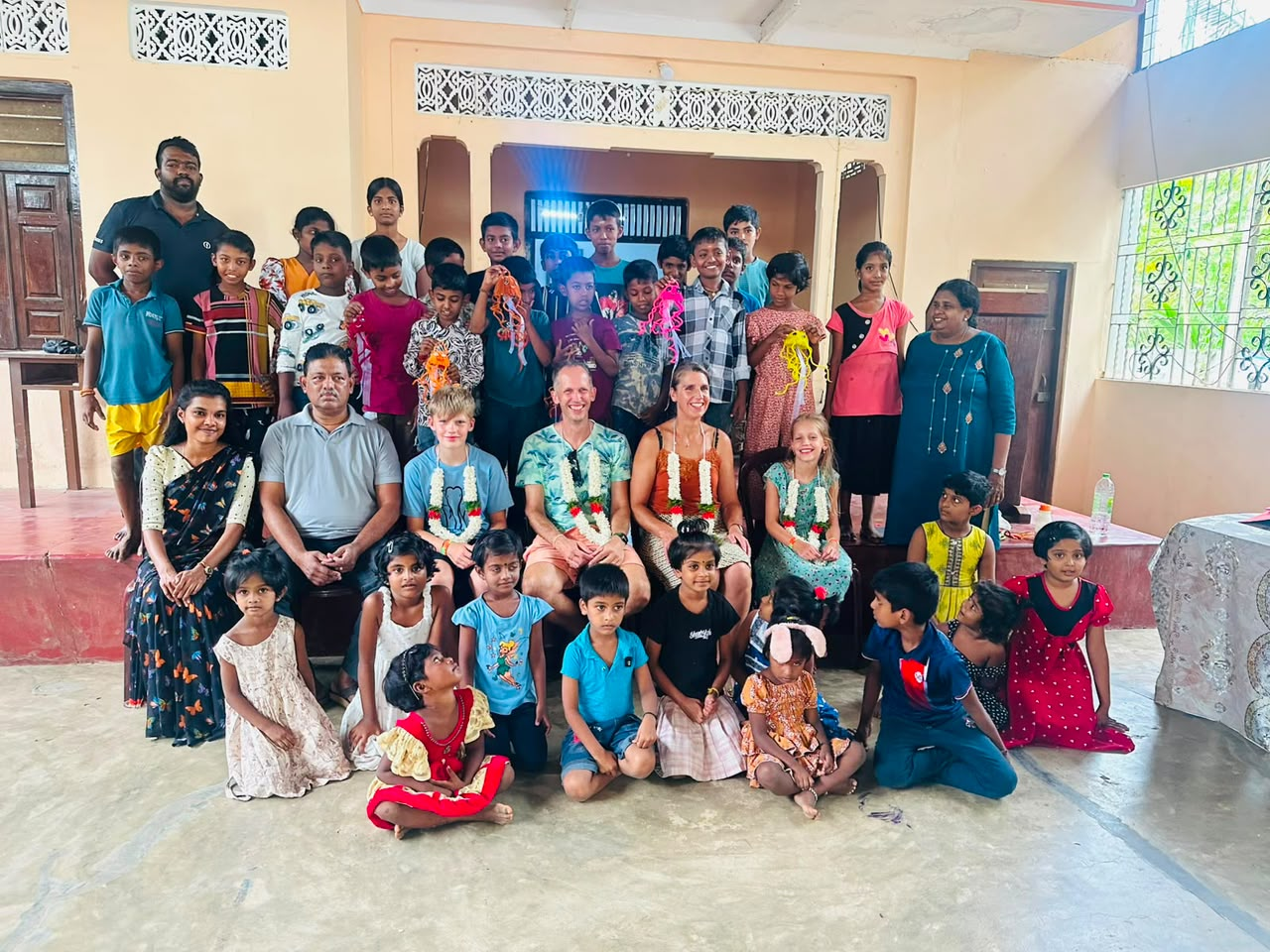 Children and CPYE staff with visiting partners, celebrating together